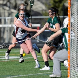 Westborough High School's Nicole Foster (#40, left) blasts her shot past Duxbury High School's Katie Smith (#6, right center) and goal keeper Charlotte Wahle.