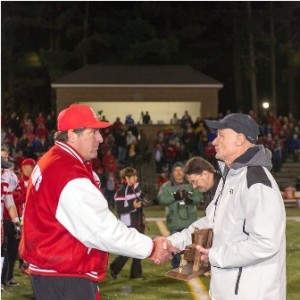 St. John's High School head coach John Andreoli, left is congratulated by MIAA official Fran Whitten on winning the Central Division 2 championship.