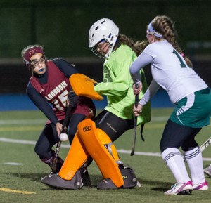 Algonquin Regional High School's Erin Berger (GK) and Clare Strickland (#15, left) team up to save this shot on goal as Nashoba Regional High School's Meghan Thorogood (#16, right) waits for the rebound.