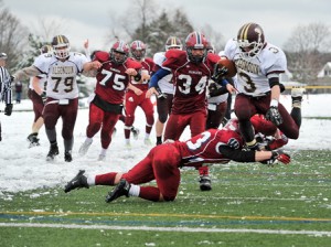 Algonquin Regional High School's Billy Polymeros (#3 leaps over Westborough High School's Adam Frye (#23, bottom) to score the winning touchdown with 1:02 left to give Alonquin the 17-14 win/
