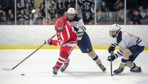 St. John's High School's Jack Pitney (l), is pushed off the puck by Shrewsbury High School's Jack Tepper (center) with his teammate James Abbott (r ). 