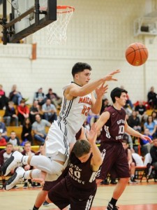 Marlborough High School's Joao Mendes passes the ball out over Groton Dunstable Regional High School's Ethan Cook.