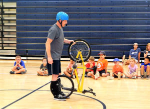 Poulos uses bicycle stunts to illustrate life lessons