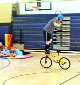 Poulos uses bicycle stunts to illustrate life lessons