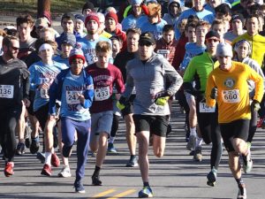Hundreds of runners begin the Westborough Turkey Trot. Isaac Grosner of Westborough (far right, bib #660) finished first overall in 16.37.
