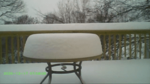 A screenshot shows part of a time lapse video of snow falling in Hudson. 