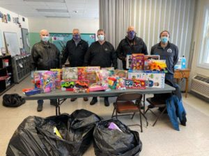 Members of the Masonic Lodge with gifts they donated to Friendly House children. 