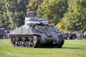 Reenactors drive a World War II era tank during a past event. The American Heritage Museum will be starting up tanks like this on multiple occasions through the rest of 2021. 