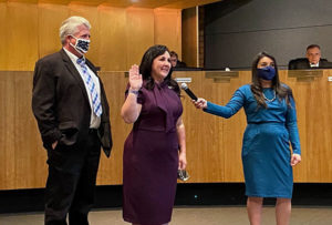 Brigette Peterson (center) gets sworn in as mayor of Gilbert, Ariz., as her husband Mark watches and Town Clerk Chaveli Herrera holds the mic. 
