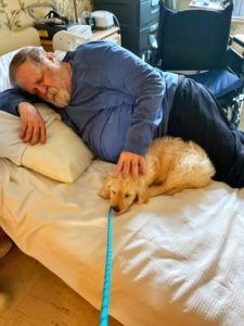 Resident John Goreschak cuddles with Gracie, early puppy days