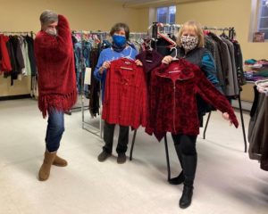Diane Barrette, Nancy Carlson and Peggy Yankee have fun showing off some of the clothing for sale at St. Stephen’s Elite Repeats Thrift Shop