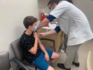 Thirteen-year-old Gavin Butterfield of Southborough gets his COVID vaccine at a Walgreens store in Worcester. 