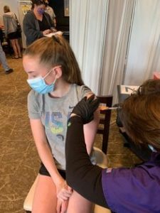 Twelve-year old Lauren Staunton gets a COVID-19 vaccine at the DoubleTree Hotel regional vaccination site in Westborough, May 13. Photo/Amy Staunton