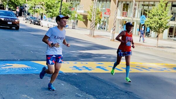 Connie Cao and son Enchee Xu cross the finish line of the 2020 Boston Marathon, which was a virtual race due to the pandemic. This year, they will run the 2021 Boston Marathon together to raise money for the Flutie Foundation.