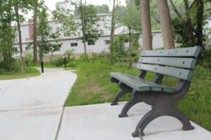 A bench sits along the Assabet River Rail Trail near Villa Do Porto Boulevard in Hudson.   Photo/Laura Hayes