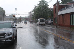 Cars drive in the rain on South Street in Hudson. Hudson approved a new wayfinding sign system to guide visitors in the downtown area.