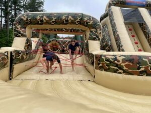 Hudson youth police academy cadets navigate a National Guard obstacle course.
