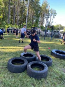  A youth police academy cadet moves through a set of tires during a workout. 