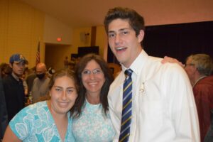 John Baird is congratulated by his sister and mother, Rebecca and Ann Baird, after graduating from the Assabet Valley Regional Technical School Practical Nursing program. His brother David looks on in the background. 