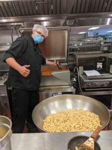 Robert Irvine, a senior in Assabet’s Culinary Arts program, prepares the pasta and sauce for a meal for the Open Table non-profit kitchen. 
