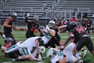 Shamrocks running back Zach Grasis strains for a first down against a crowd of Connecticut defenders in the second quarter of their game July 24. 