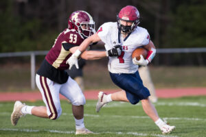  An Algonquin football player sprints to tackle a Westborough opponent earlier this year. Coaches are excited and hopeful that the Fall 2021 season will mark a return to normal after the return of traditional summer workouts.