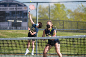  A Shrewsbury girls tennis player waits as a teammate makes a serve during a match earlier this spring. 
