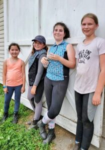  Riding school students at Maple Grove Equestrian Farm on Central Street were among those arranging a wedding ceremony for veteran ponies “Amelia Bedelia” and “Bullwinkle.” From left: Fiona Lee, Gianna Apicello, Abigail Johnson and Zoe McCuine. 