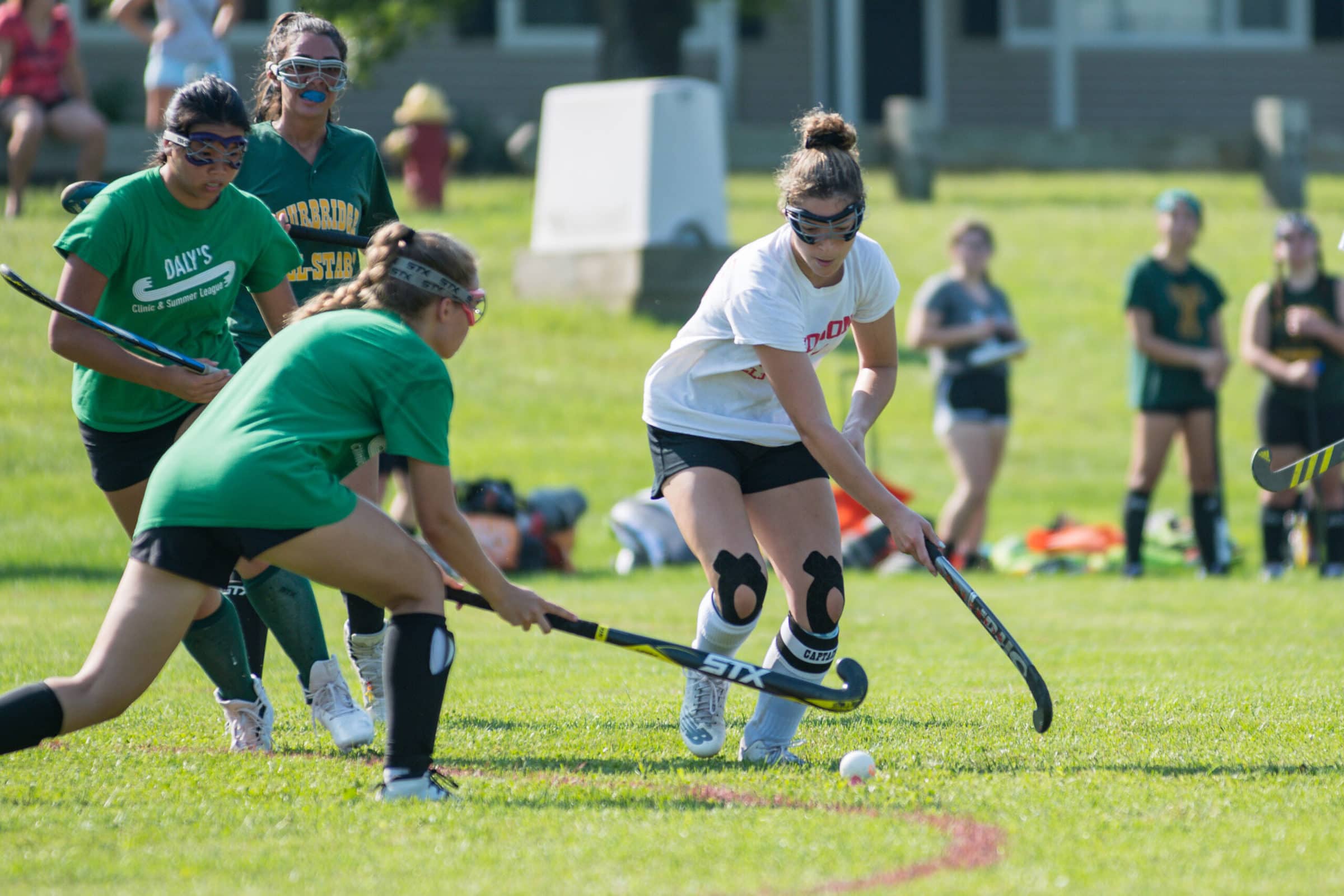 A Hudson field hockey player battles with a Tantasqua opponent for possession. (Photo/Jesse Kucewicz)
