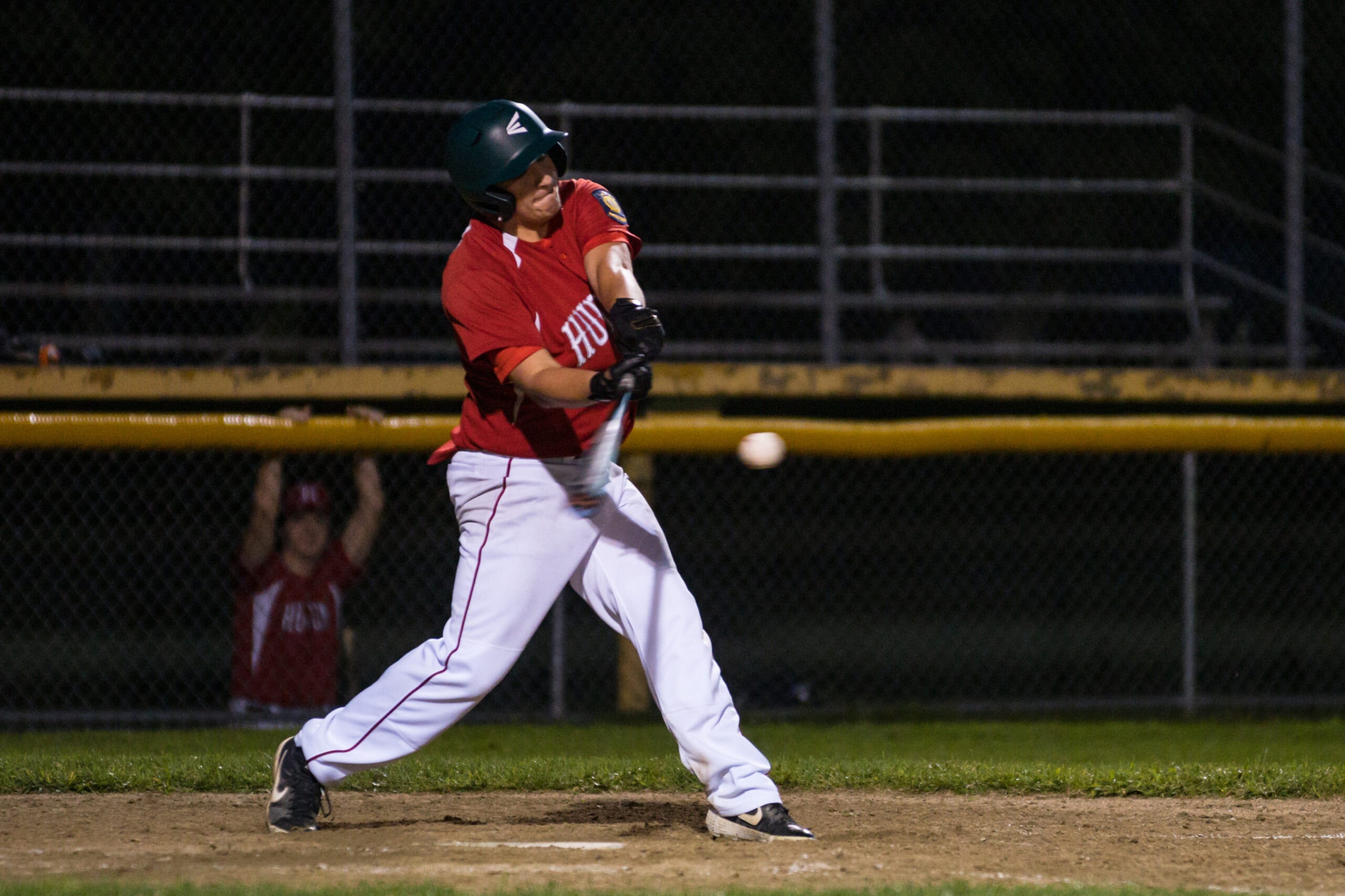 A Hudson batter swings on a pitch as his team looked to rally late in their game against Natick.