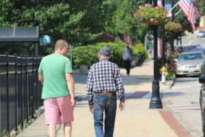 Two people walk down Main Street in Marlborough on Aug. 27.  Photo/Laura Hayes