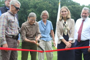  Nora O’Donnell cuts a ribbon for the land to join Callahan State Park.