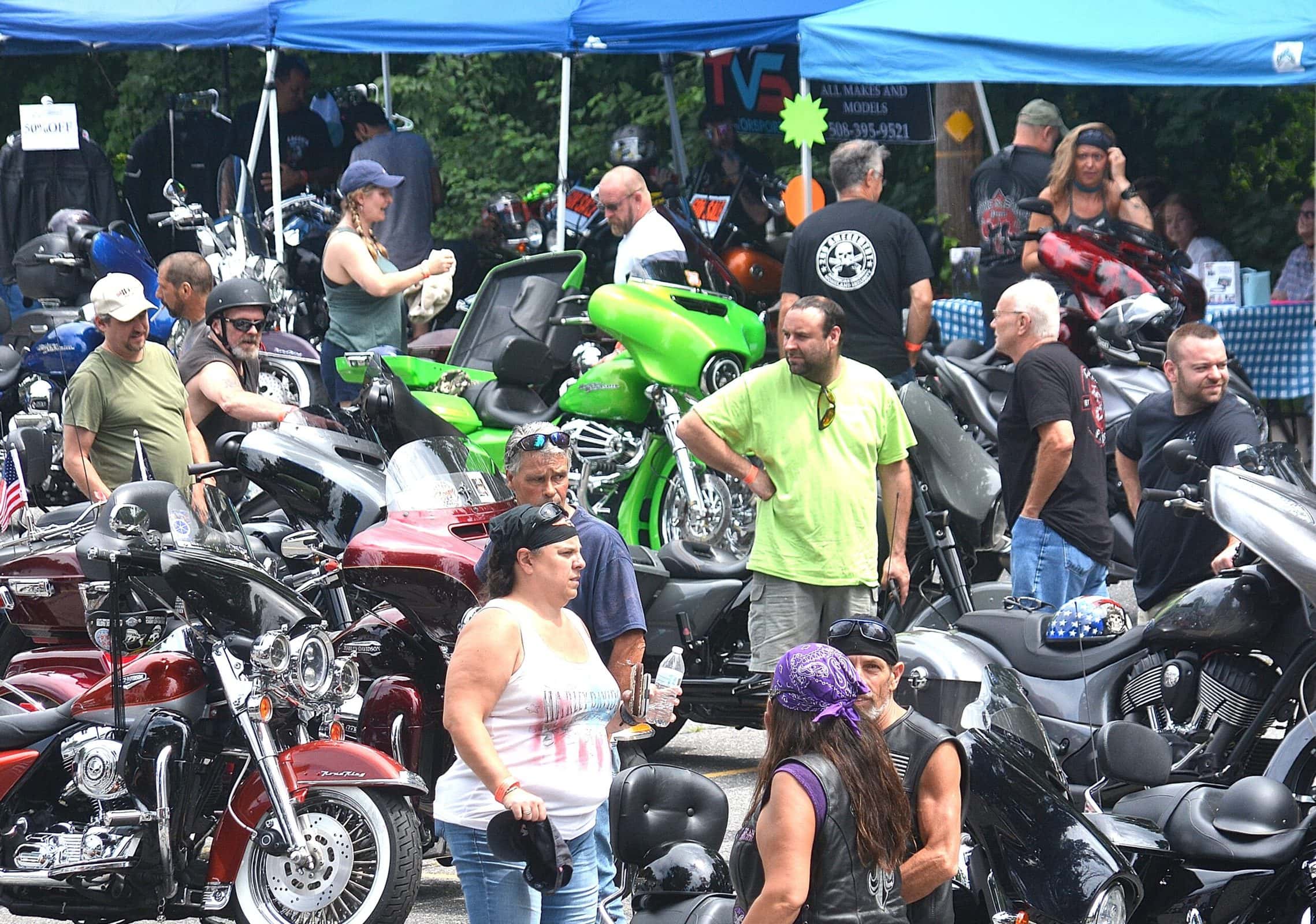 Ride participants mingle among their motorcycles parked outside the Marlborough Moose.