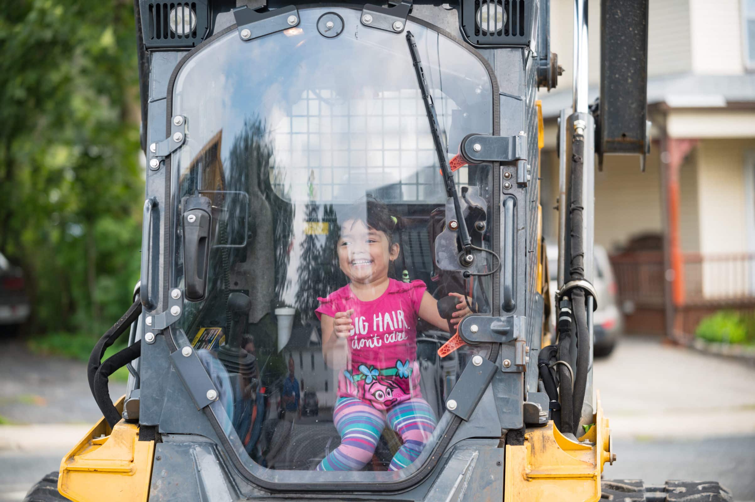 A young person smiles while sitting in the cab of a Marlborough DPW truck. (Photo/Jesse Kucewicz)
