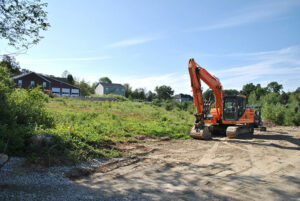 An excavator sits near the site of a proposed nine-lot subdivision on South St. in Shrewsbury.  Photo/Dakota Antelman