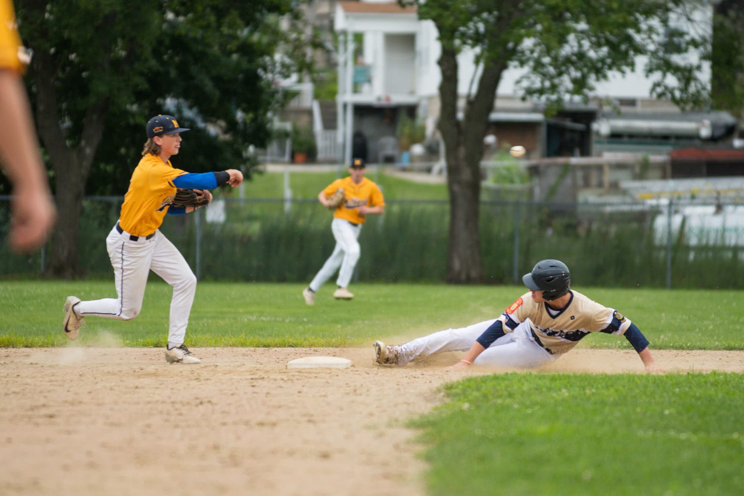 A Shrewsbury base runner slides into second base after already being tagged out by a Milford fielder. (Photo/Jesse Kucewicz)