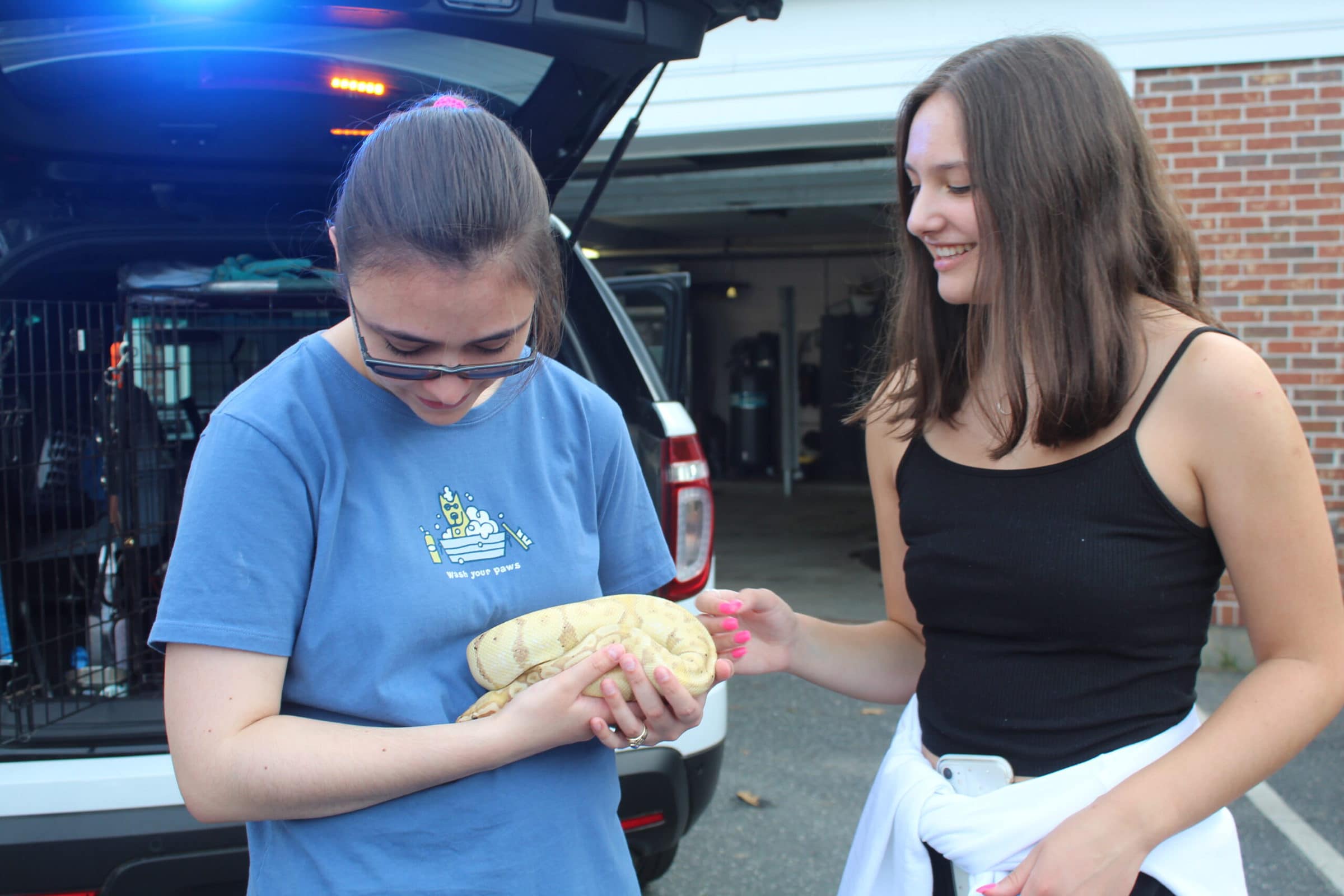Julia and Emma Casavant hold a snake during National Night Out.