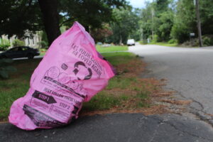 A pink, pay-as-you-throw textile recycling bag sits on Brook Street in Shrewsbury.  (Photo/Laura Hayes)
