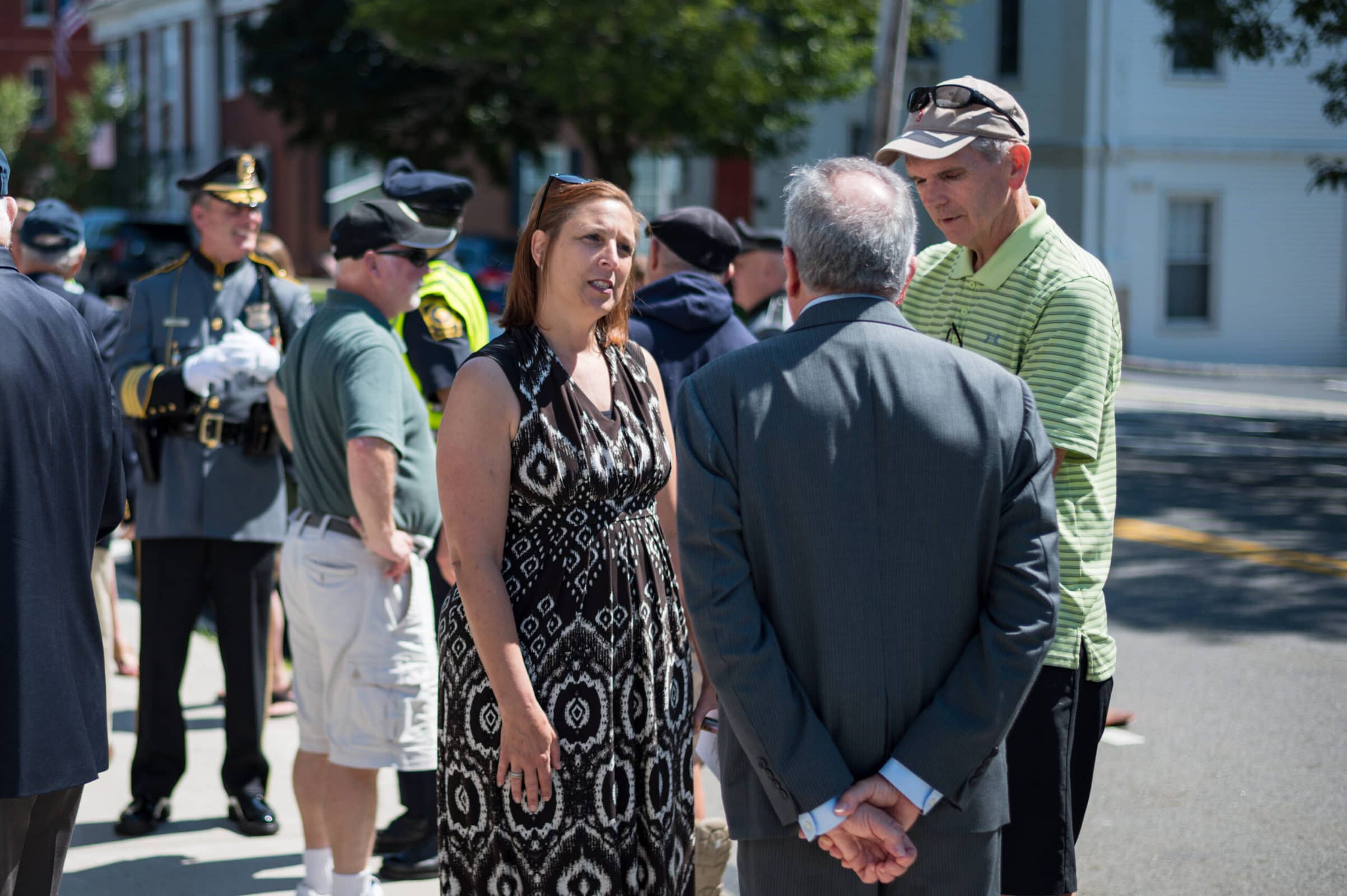 Attendees of a plaque dedication ceremony in honor of Westborough’s Michael Haskell mingle in front of the Forbes Municipal Building in town. (Photo/Jesse Kucewicz)