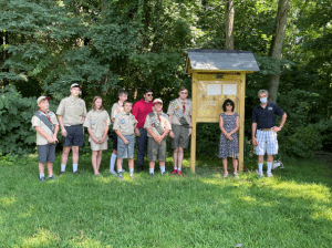  Jaxon Capobianco stands with town officials and a team of fellow scouts who helped install Capobianco’s eagle scout project kiosks at the Danforth Falls Conservation Land. 