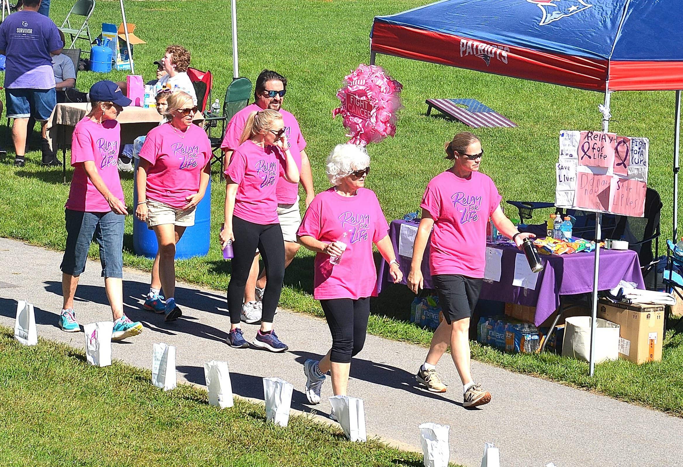 A team called Mal’s Gals walks in the relay in memory of their co-worker, who died of cancer this year.