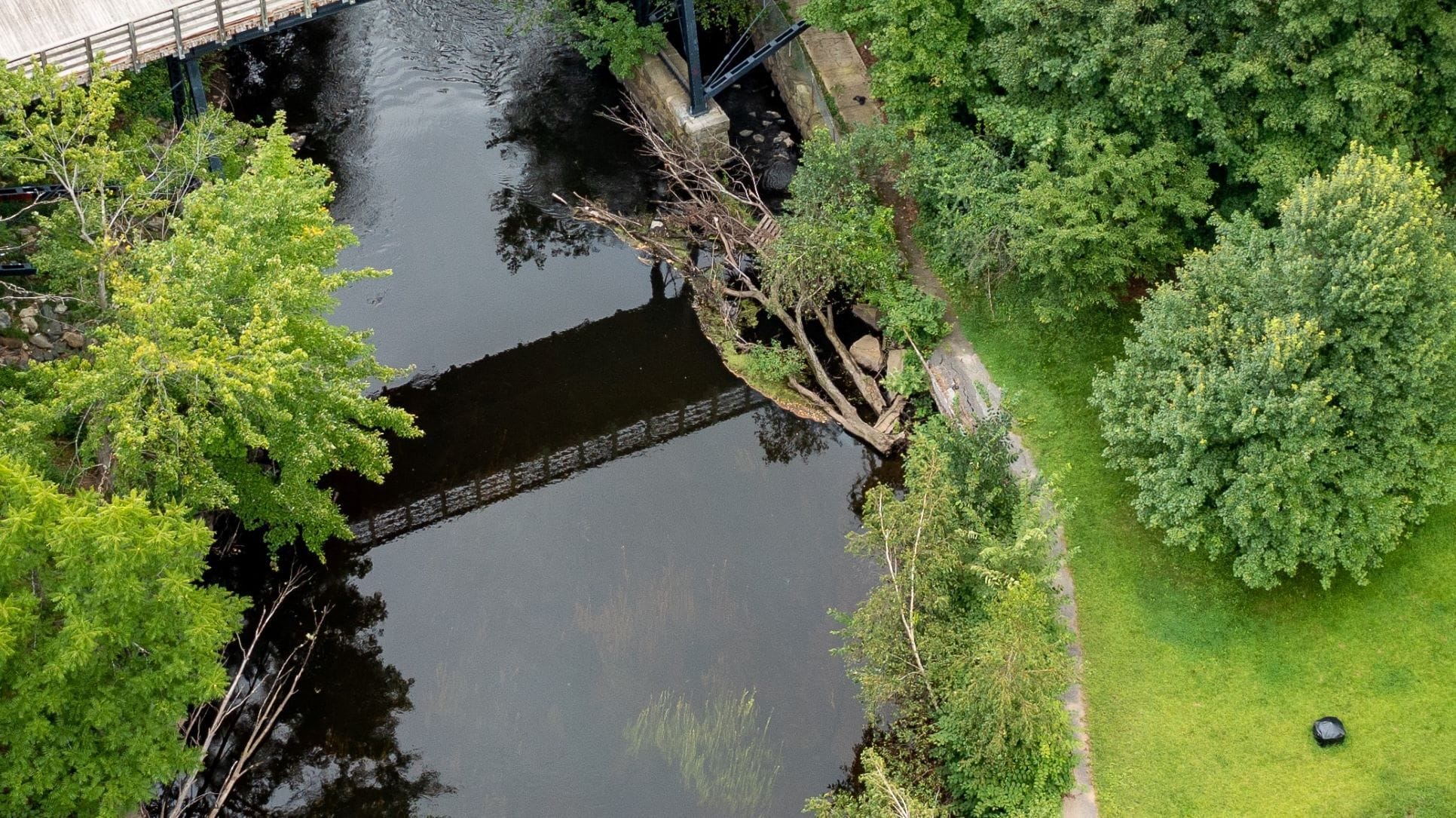 The historic walkway between Houghton and Mason Street remained closed last month, two years after part of the walkway crumbled into the nearby Assabet River. Photo/Tami White