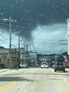 A funnel cloud dips behind the buildings and Main Street panorama of downtown Hudson on Aug. 23 Photo/courtesy Niki Giles