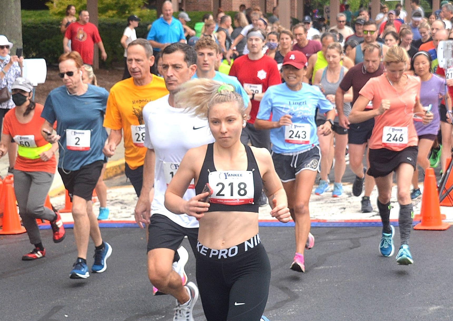 Kaitlin Johnson of Northborough (front, bib #218) is among runners beginning the Applefest 5K Road Race. She was the first-place female, finishing in 22.09.