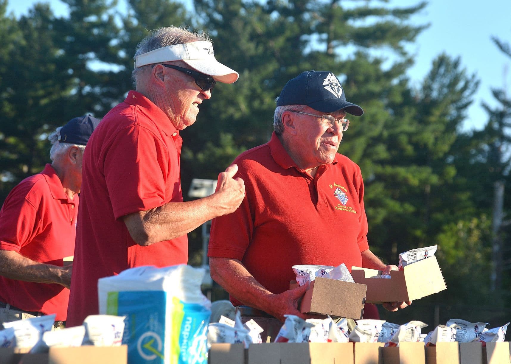 Knights of Columbus St. Augustine Council 5724 members Bob Phil and Ken Foster prepare barbecue orders.