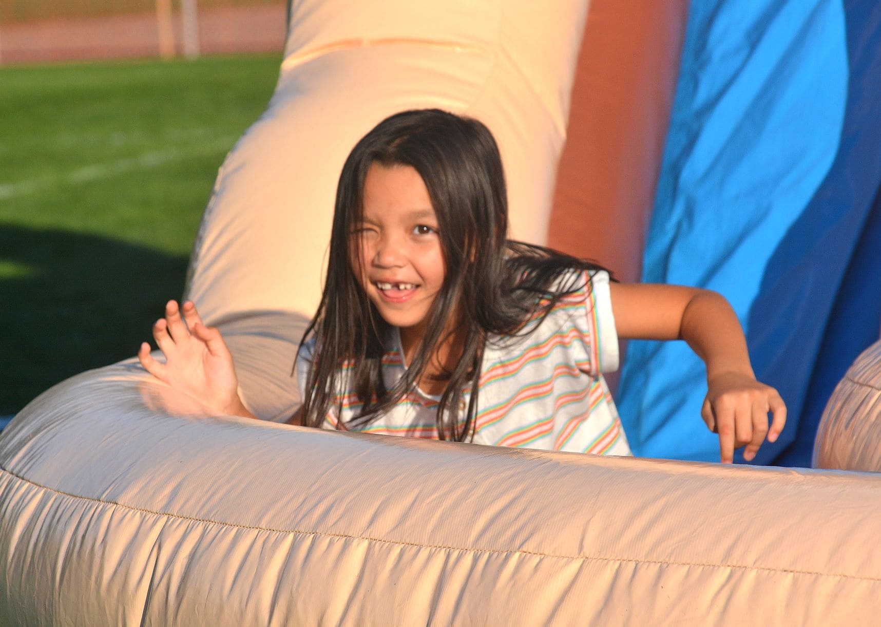 Mia Berberian, 6, glides to the bottom of an inflatable slide.