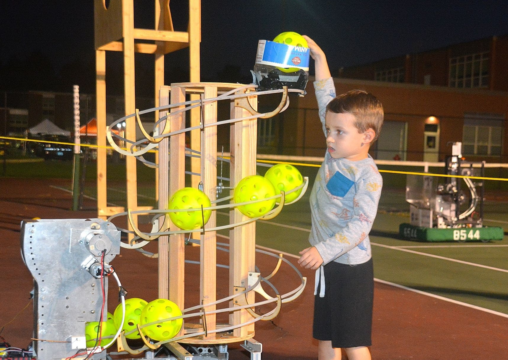 Ben Senechal, 4, reloads balls into a robot at an interactive robotics demo provided by Algonquin’s Robotics Team.