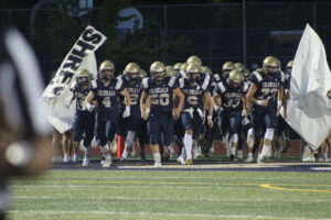 Shrewsbury players charge onto the field before a home crowd on Sept. 25. 