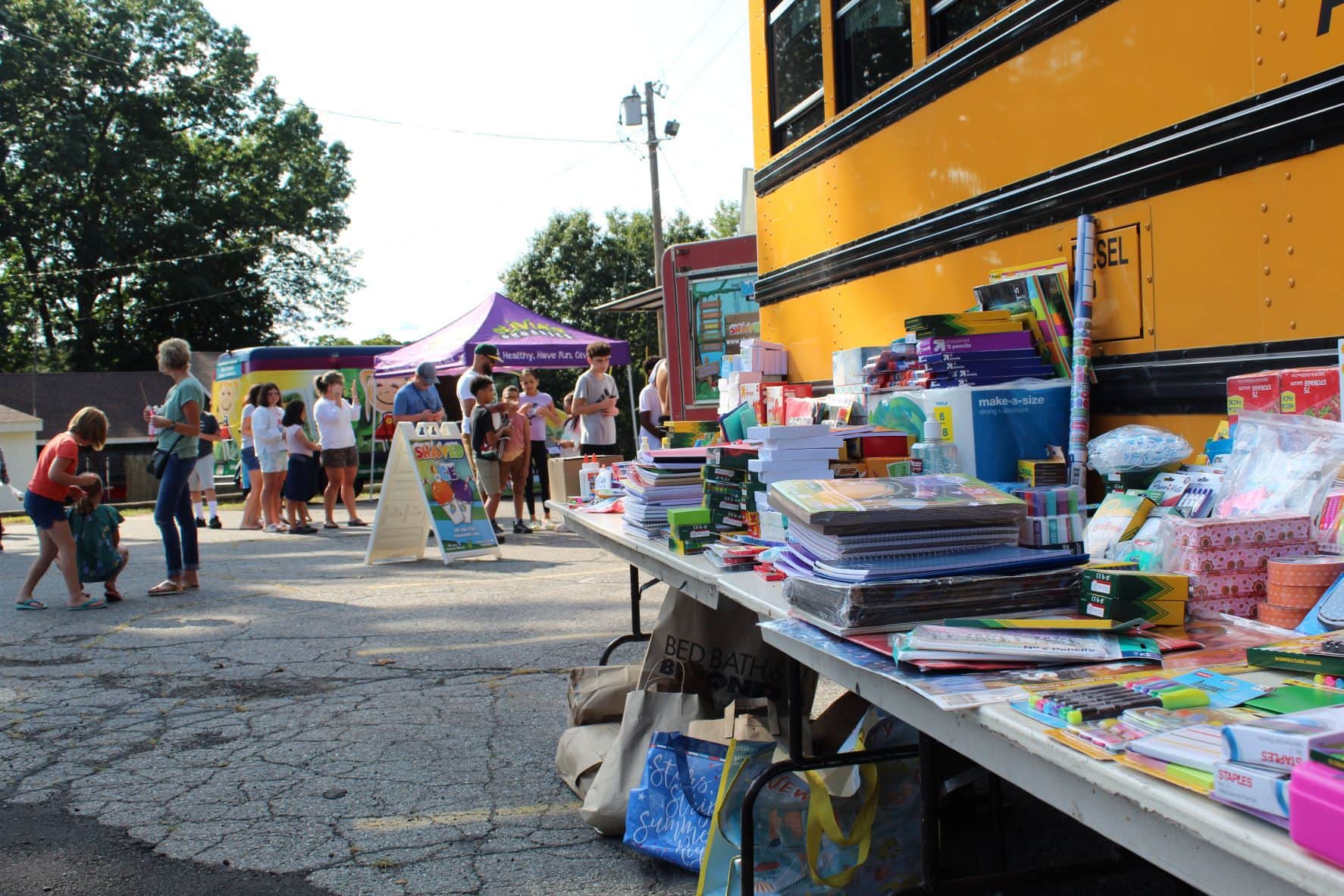 Festival attendees brought schools supplies, which were lined up against a school bus.