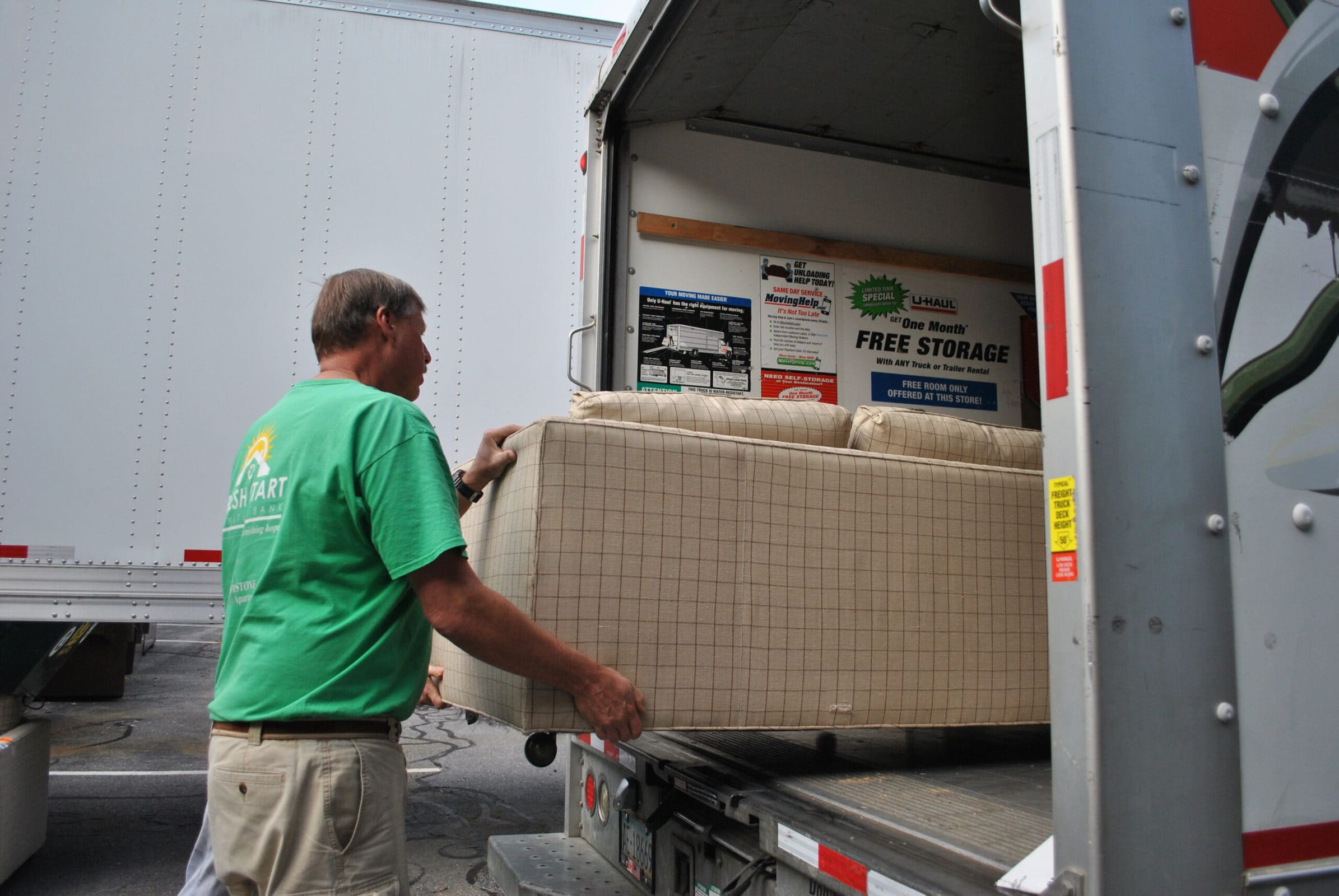 Fresh Start Furniture Bank volunteers load furniture into a waiting U-Haul truck. (Photo/Dakota Antelman)